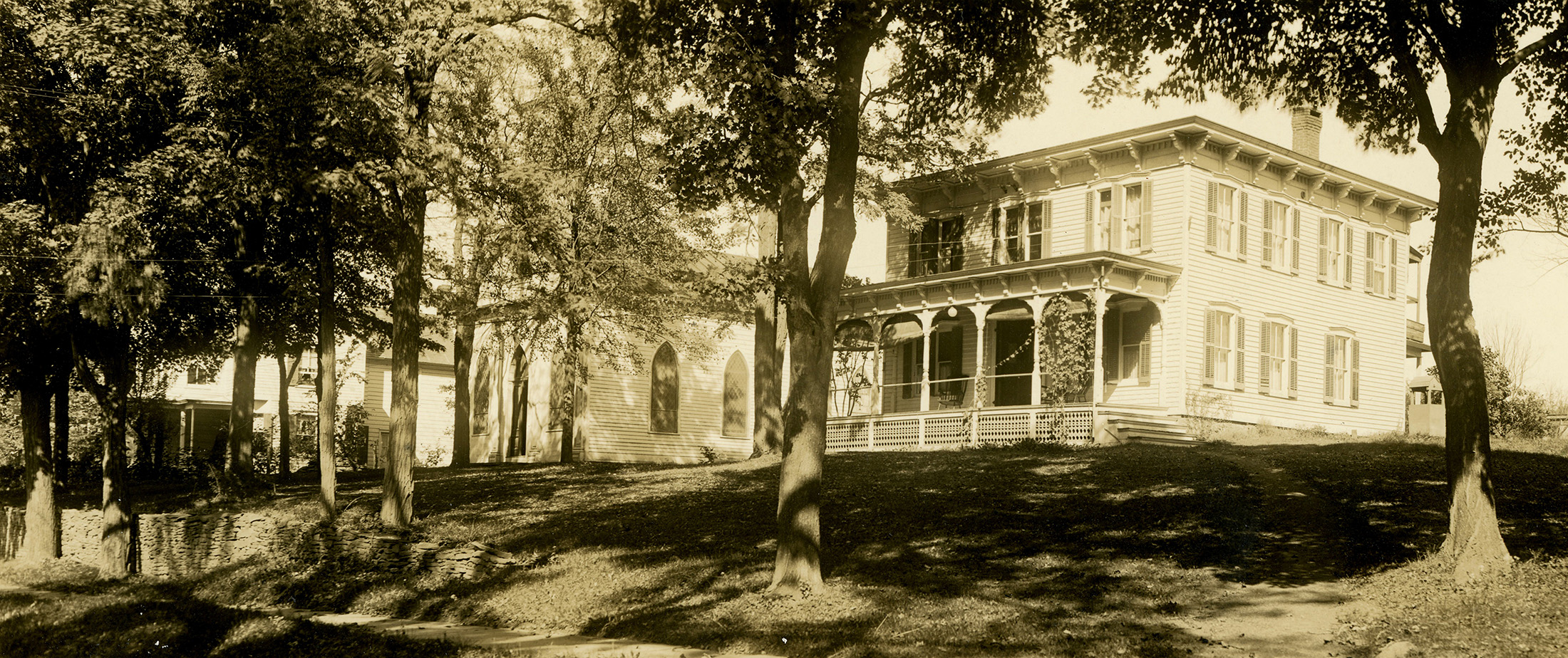 black and white photo showing a bracketed cottage