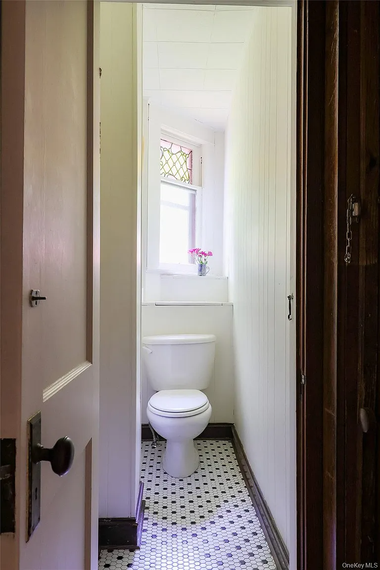 bathroom with black and white hex tile floor
