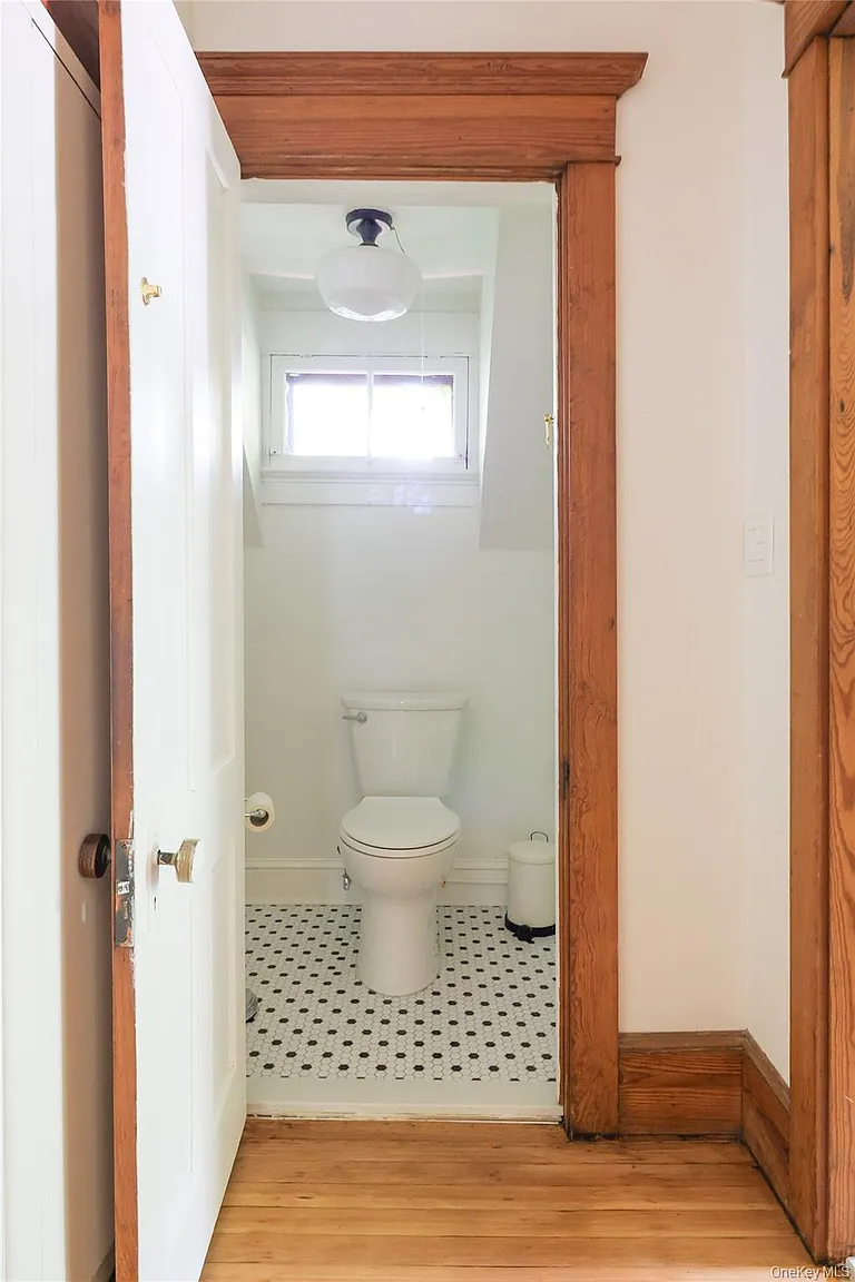 bathroom with black and white hex tile floor