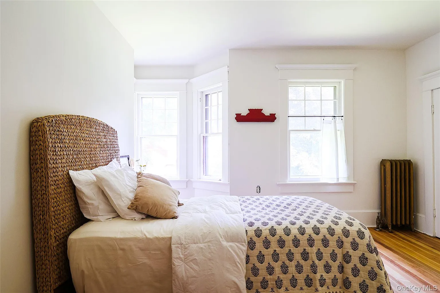 bedroom with wood floor, white walls