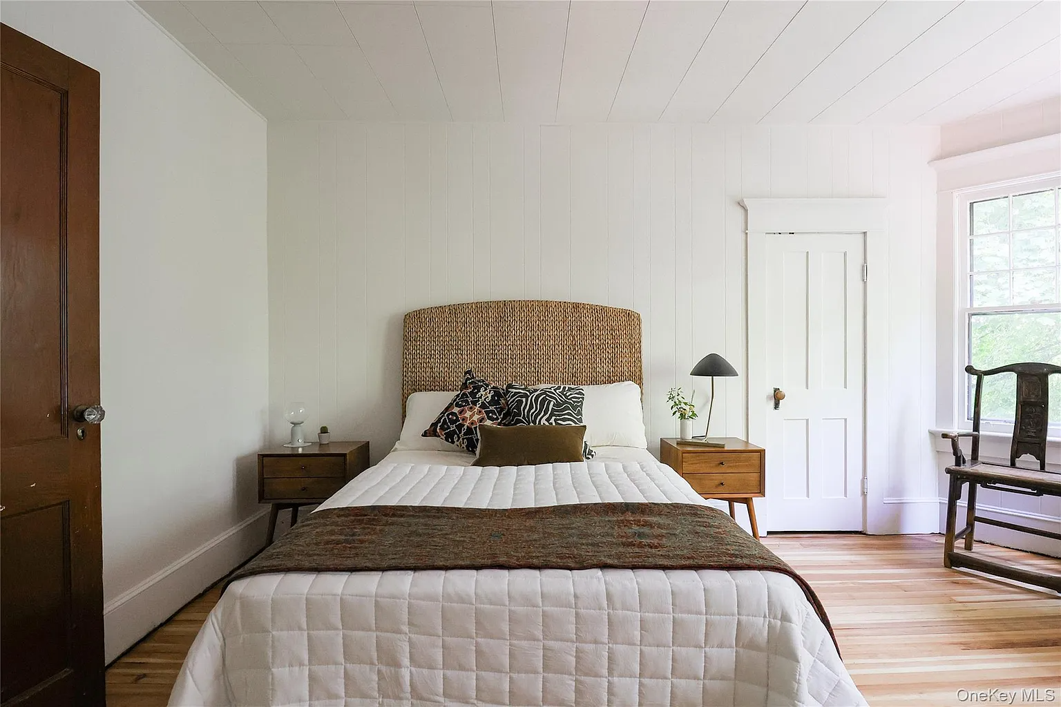 bedroom with wood floor, white walls