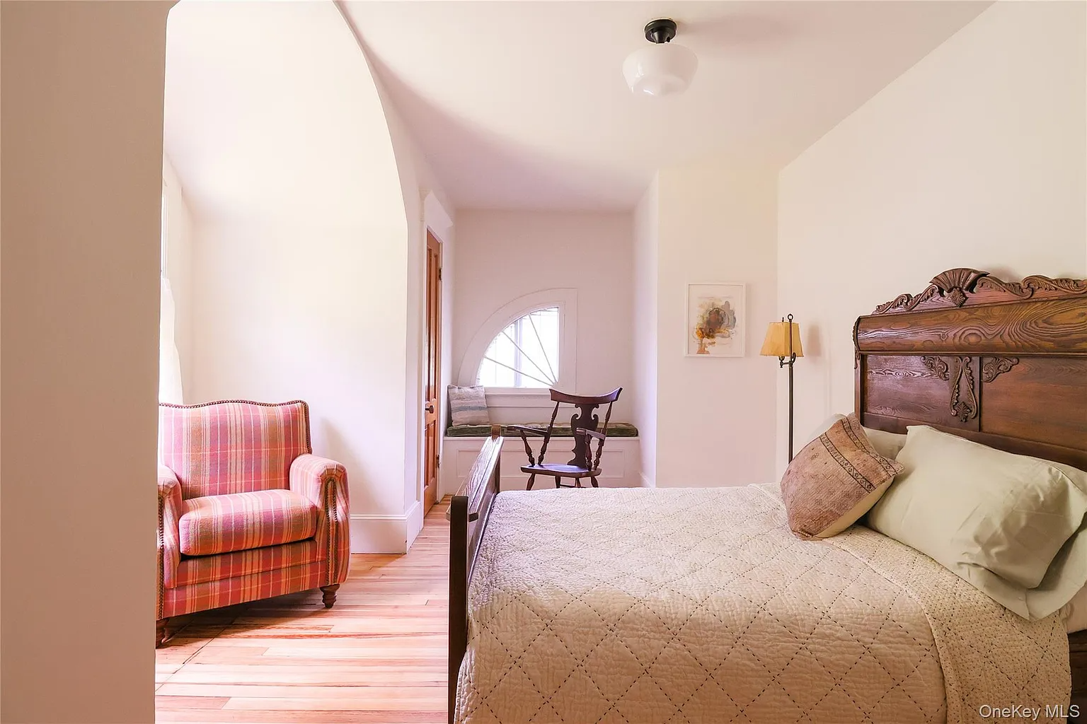 bedroom with wood floors, white walls