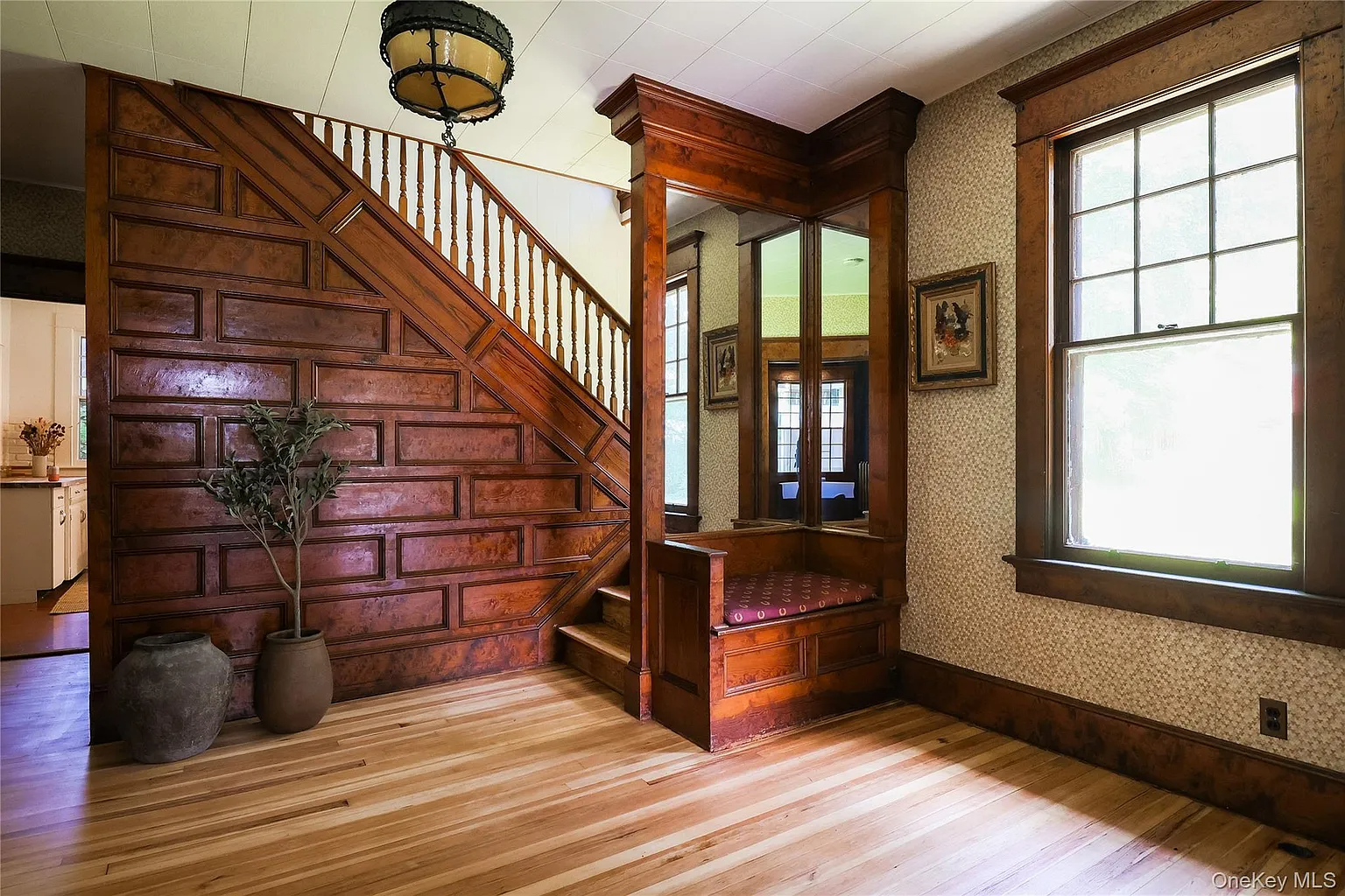 center hall with stair with built-in bench and mirror