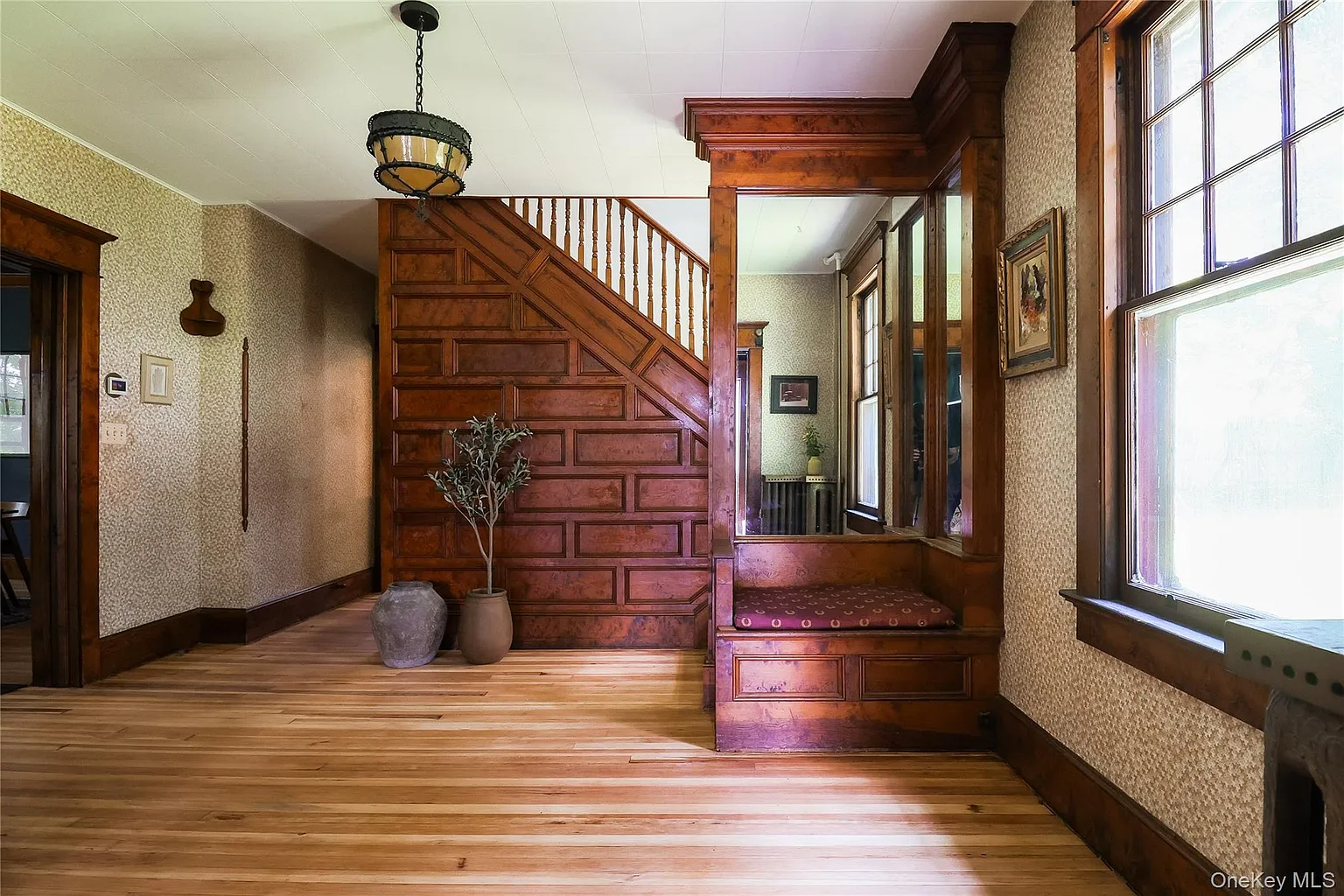 center hall with stair with built-in bench and mirror