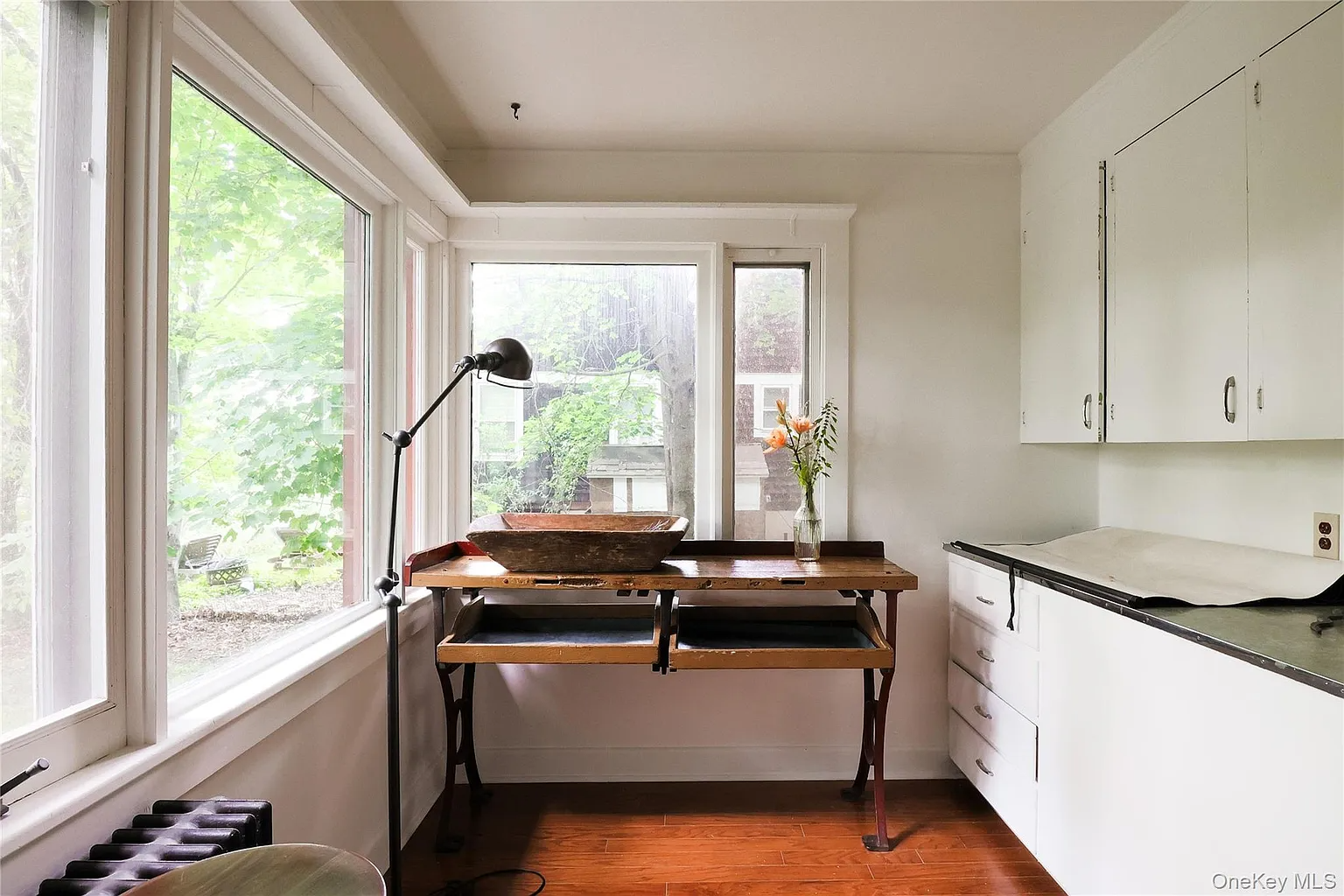 office with two exposures, bank of vintage white metal cabinets