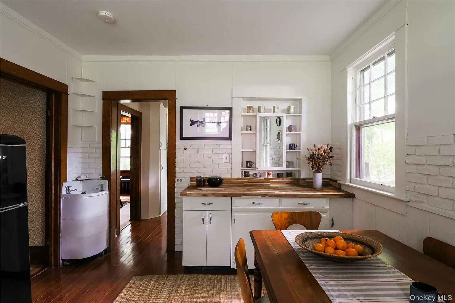 kitchen with vintage white cabinets including corner sink cabinet