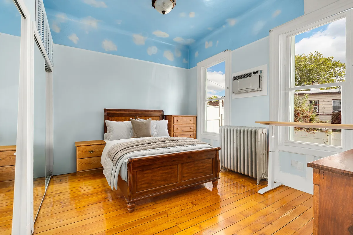 bedroom with clouds painted on ceiling