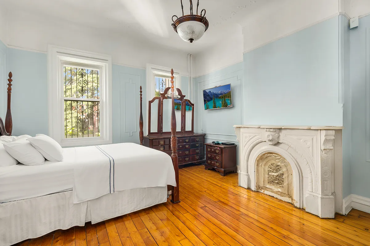 bedroom with marble mantel, blue walls