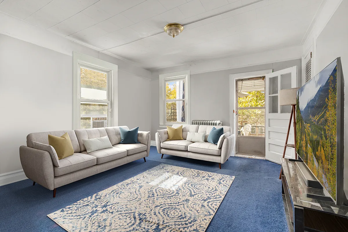 living room with blue carpet, two exposures, door to terrace