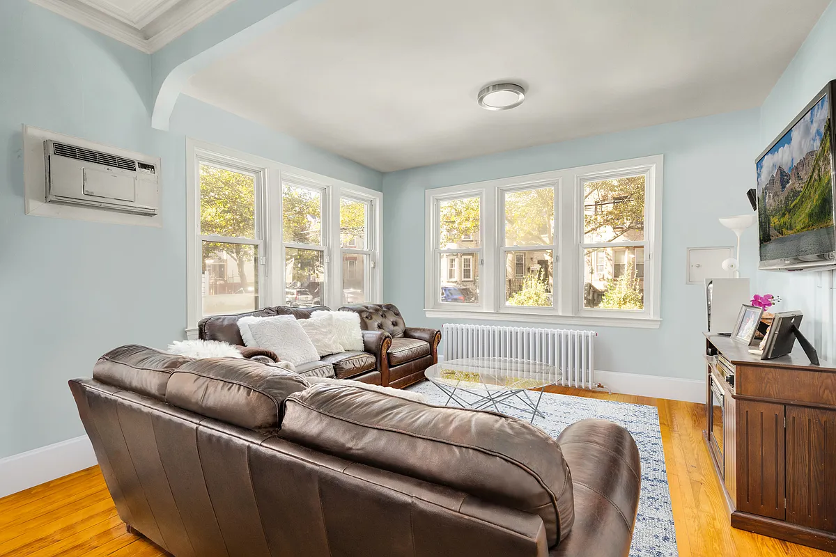 living room with pale blue walls, two exposures