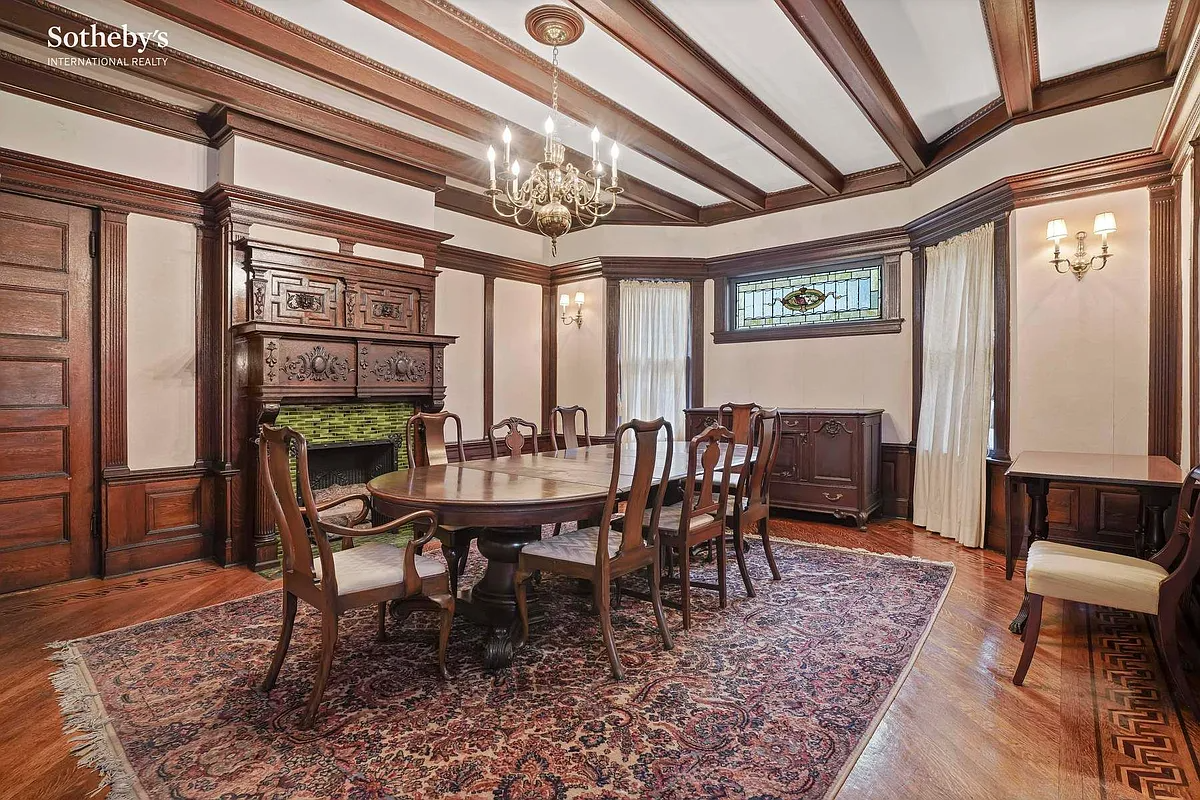dining room with beamed ceiling, mantel