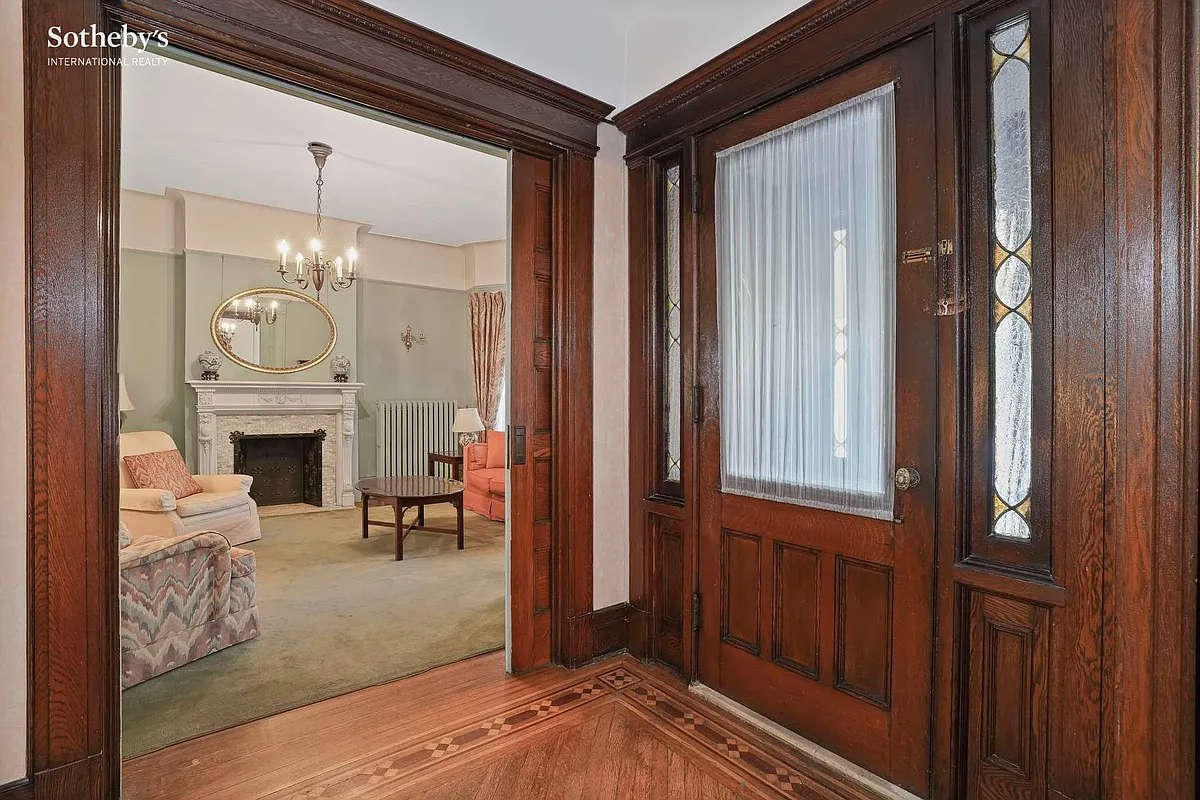 entry with wood floor, front door with side lights