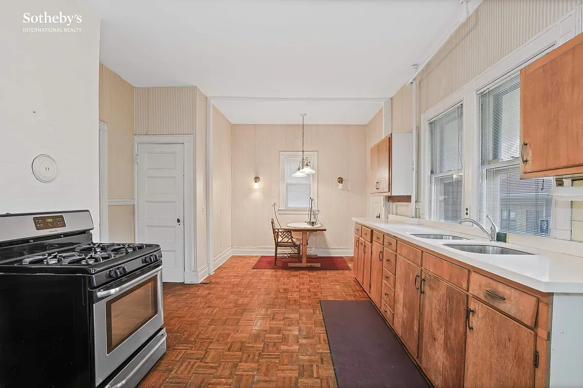 kitchen with wood cabinets, wood floor
