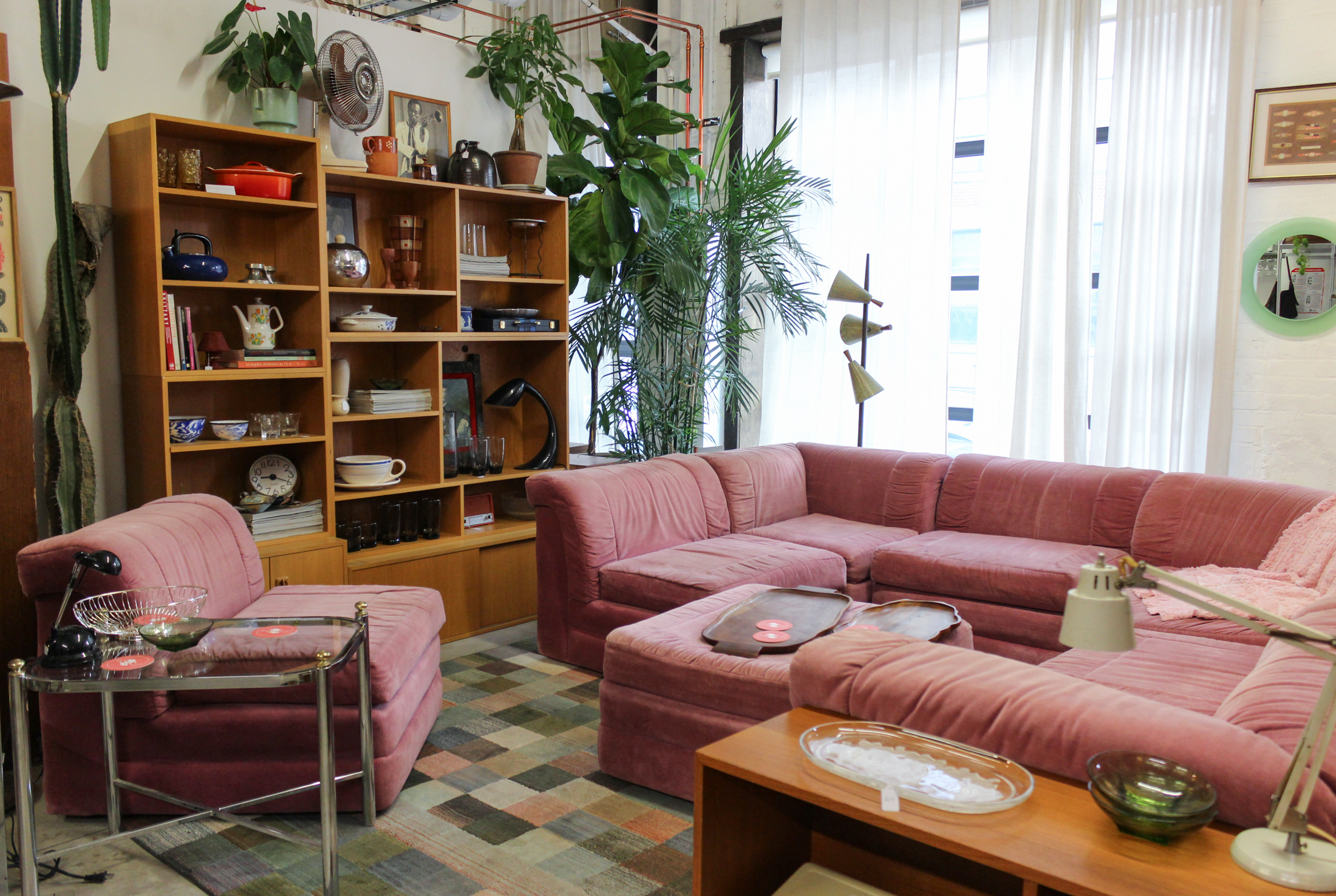 seating area with pink sofas and chairs