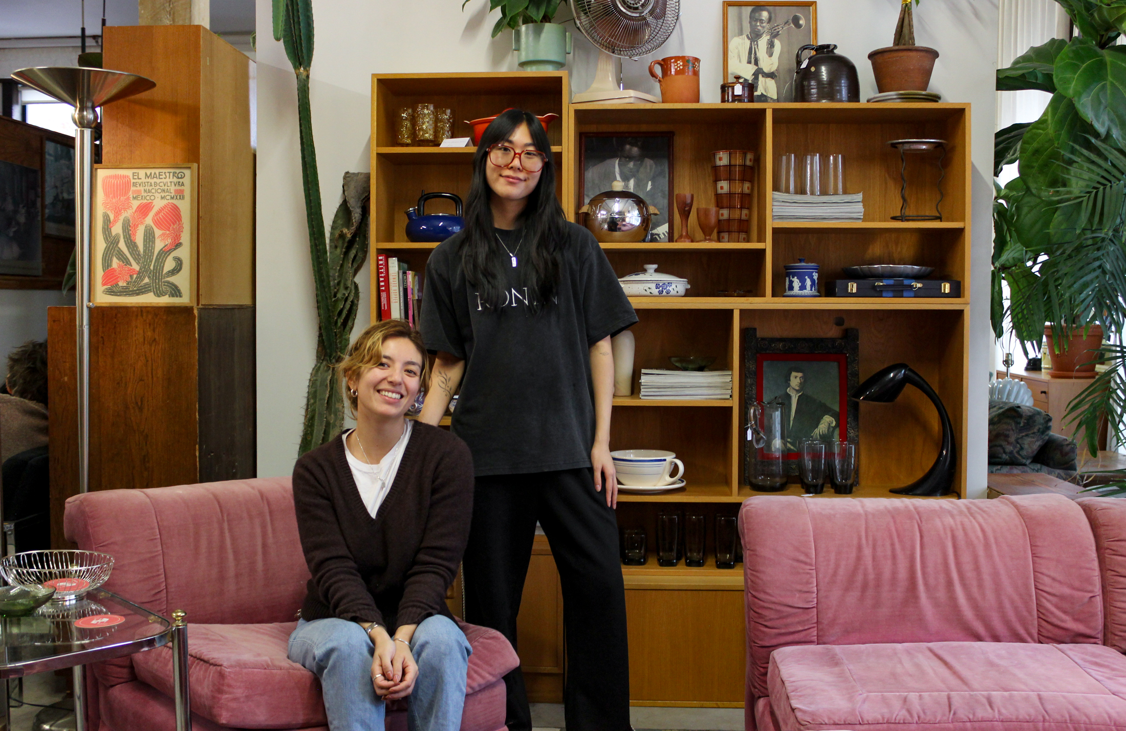 people posing amidst vintage furniture