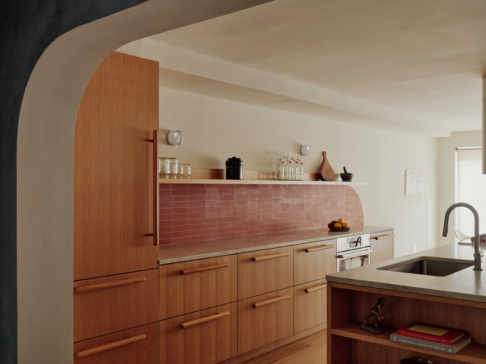 KITCHEN WALL OF WOOD CABINETS RED TILE WORK WITH CURVE