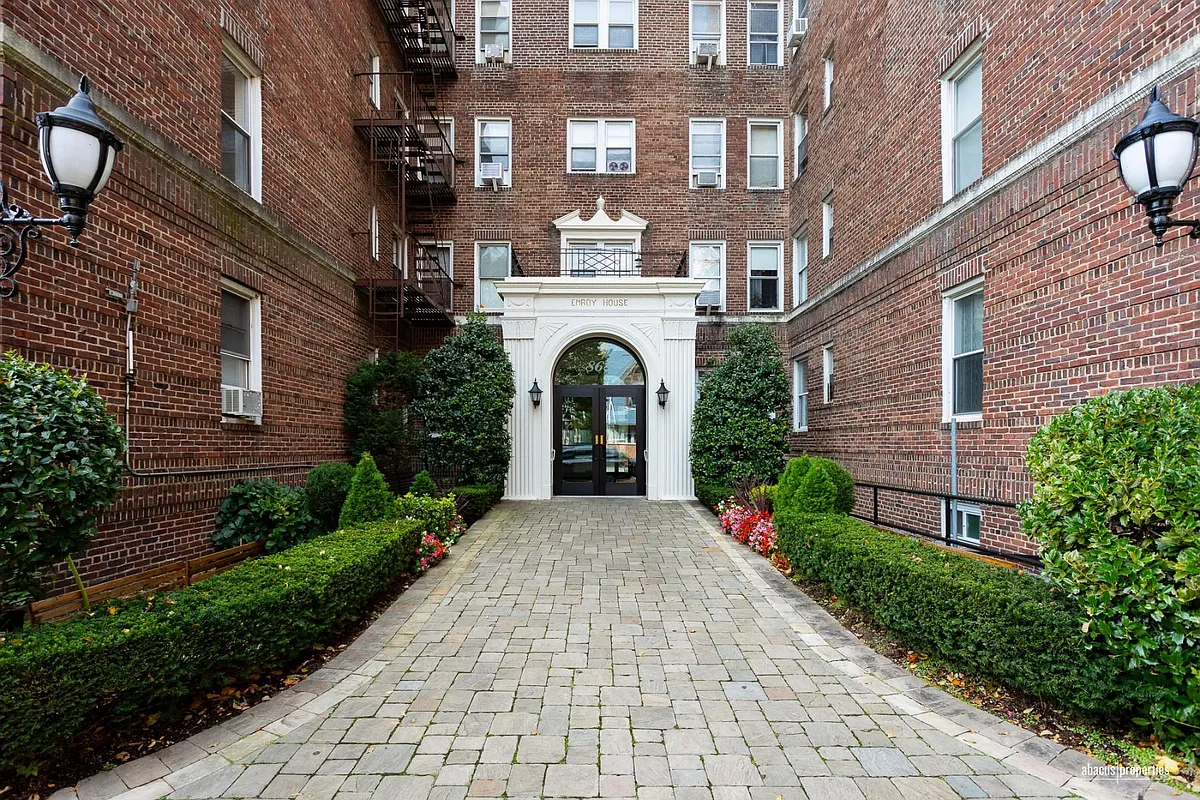 arched building entrance with pilasters and "emroy house" signage