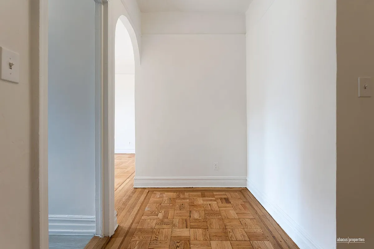 foyer hall with arched doorway to living space