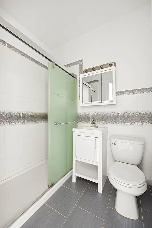 bathroom with gray tile, shower