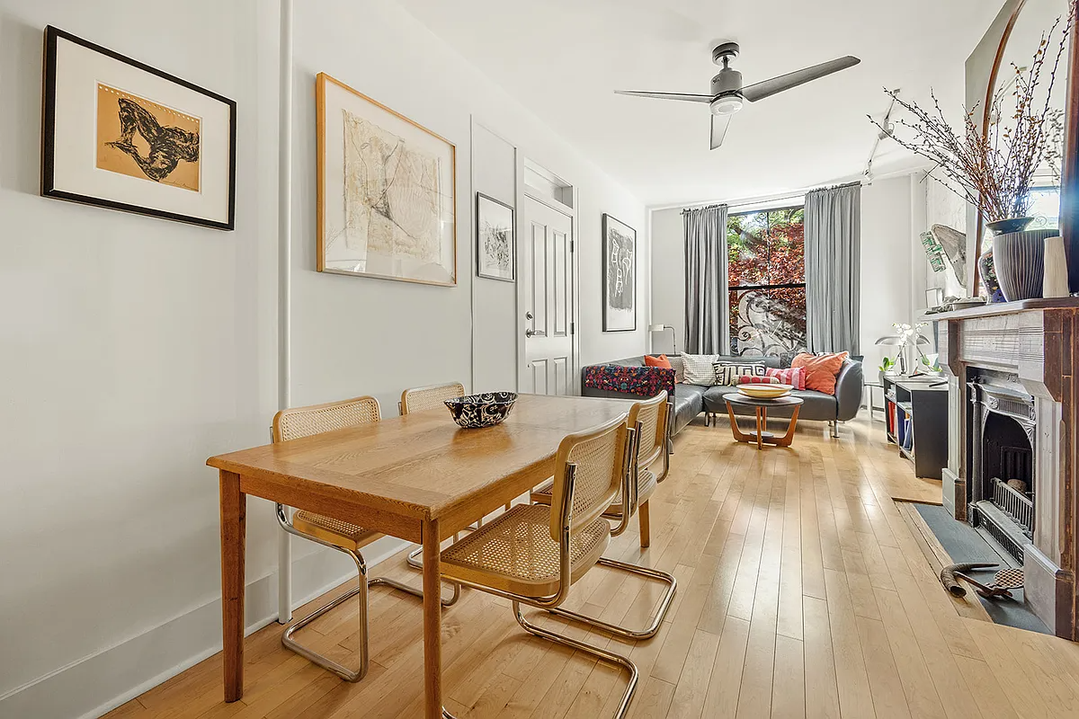 parlor with wood floors, mantel