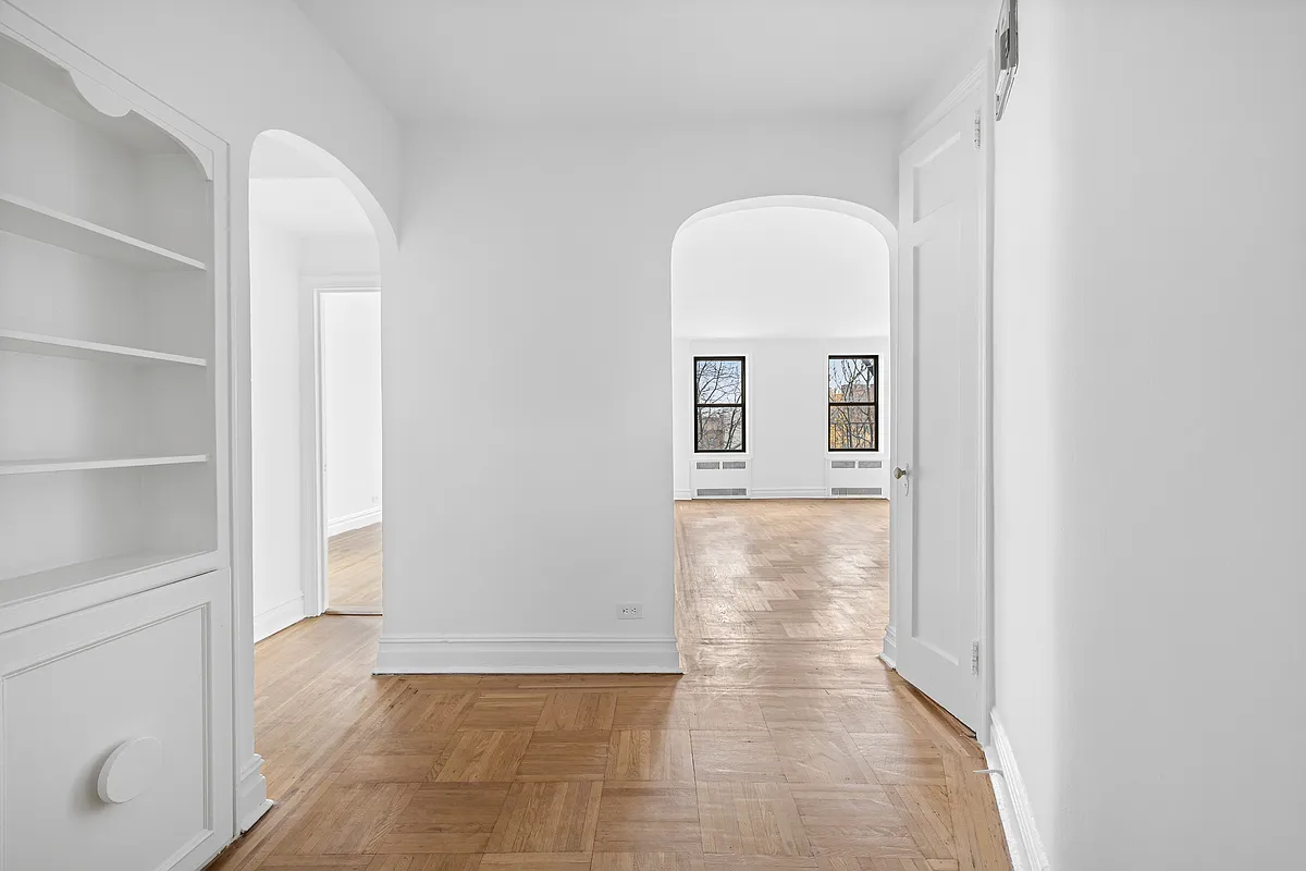 foyer with arched doorways, niche with shelves