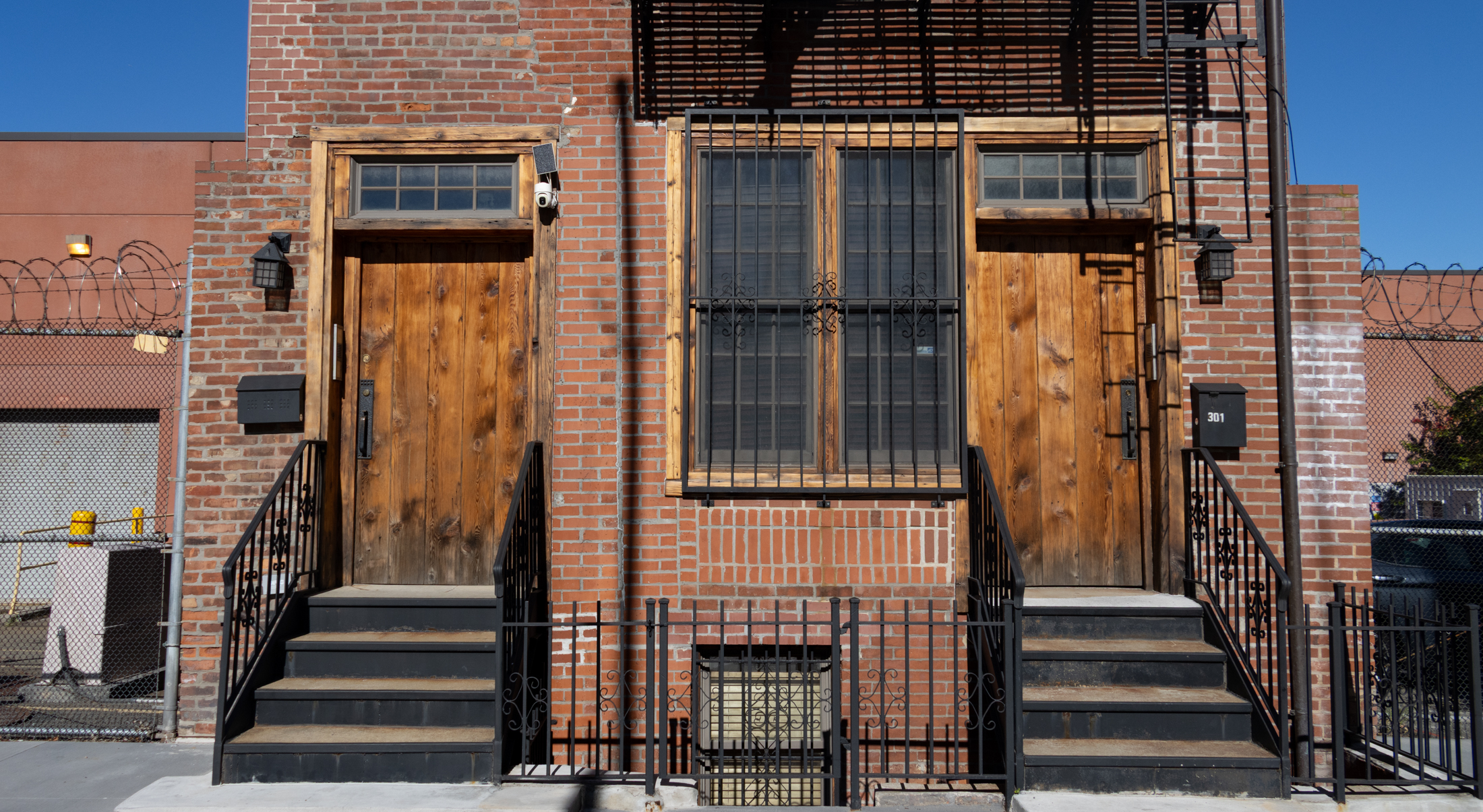 wooden front doors on a brick building