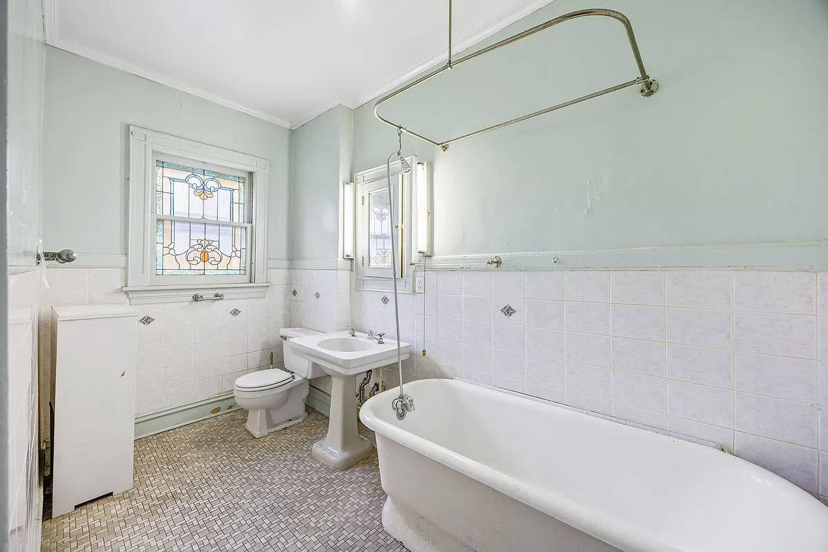 bathroom with stained glass, pedestal sink