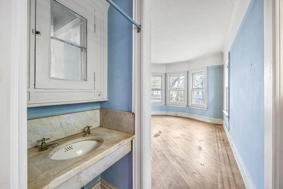bedroom with blue walls, marble sink