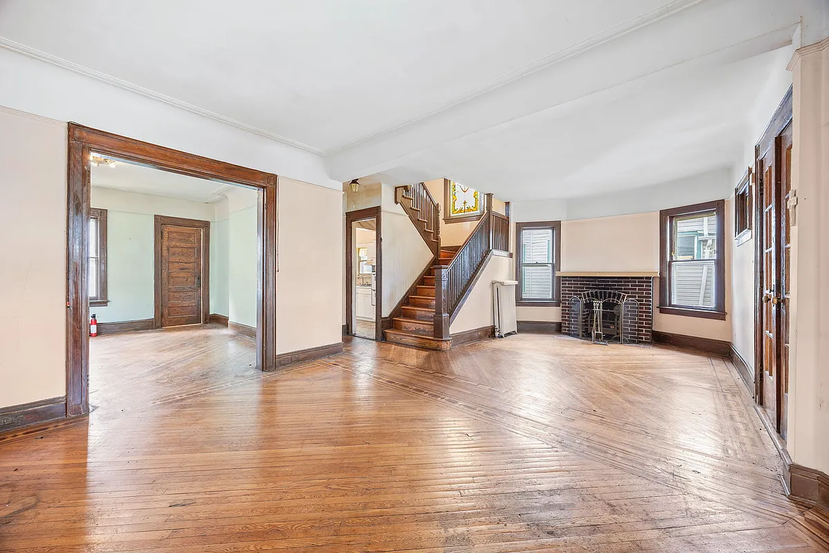 parlor with brick mantel, wood lfoor, stained glass