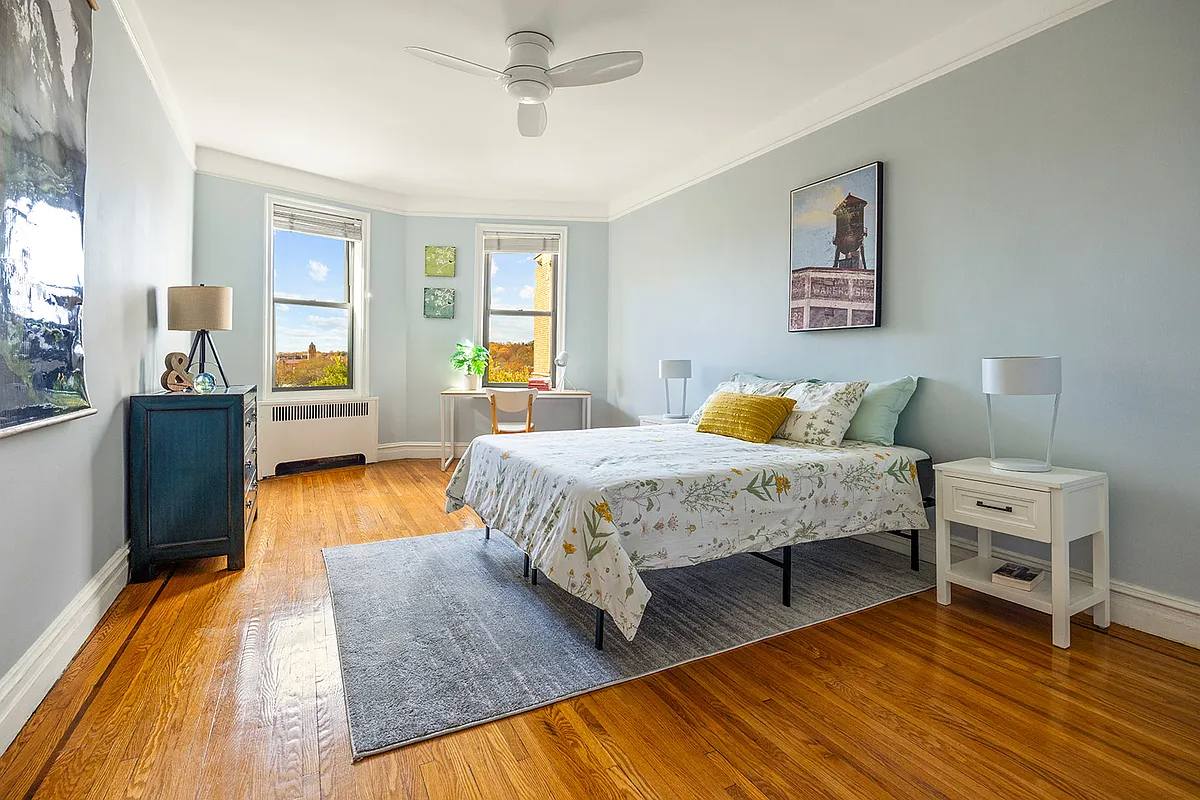 bedroom with blue walls, picture rails, ceiling fan