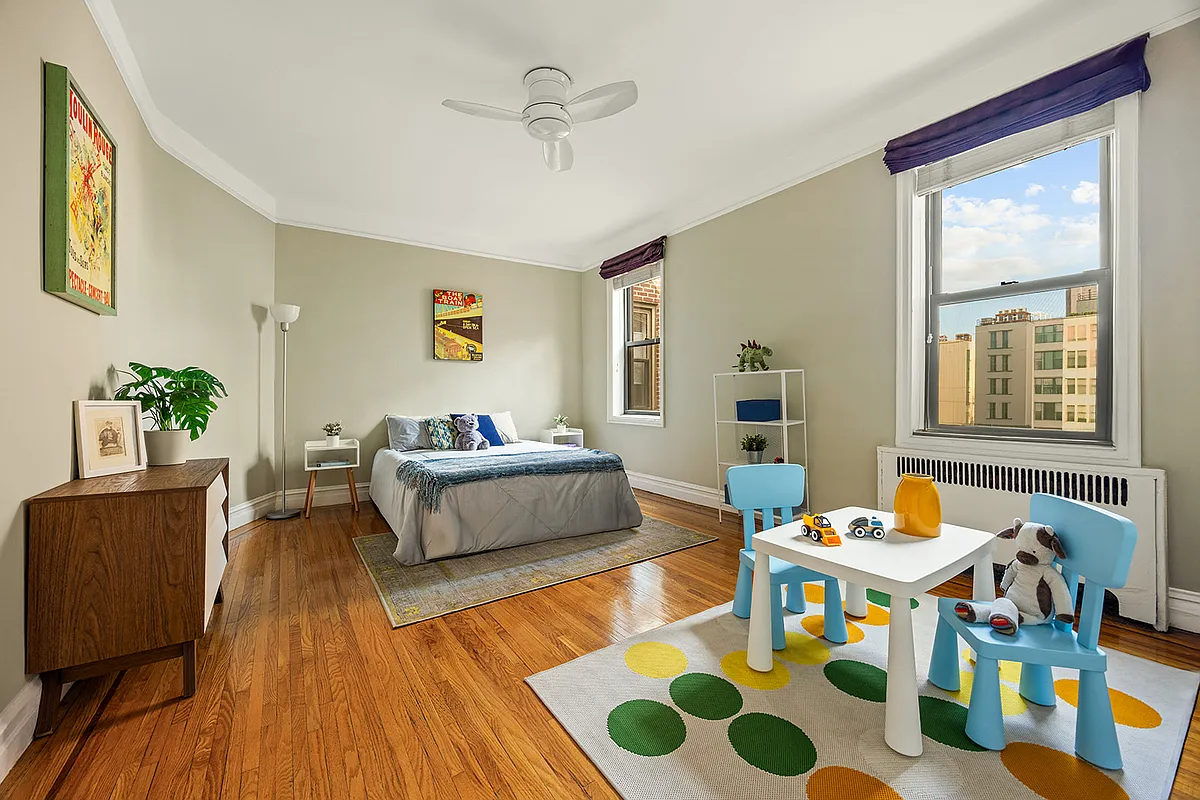bedroom with wood floor, ceiling fan, two windows
