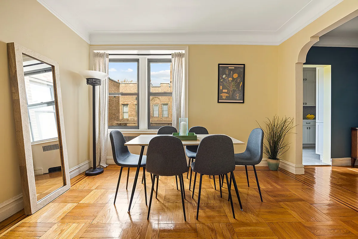 living room with wood floor, beige walls, archway