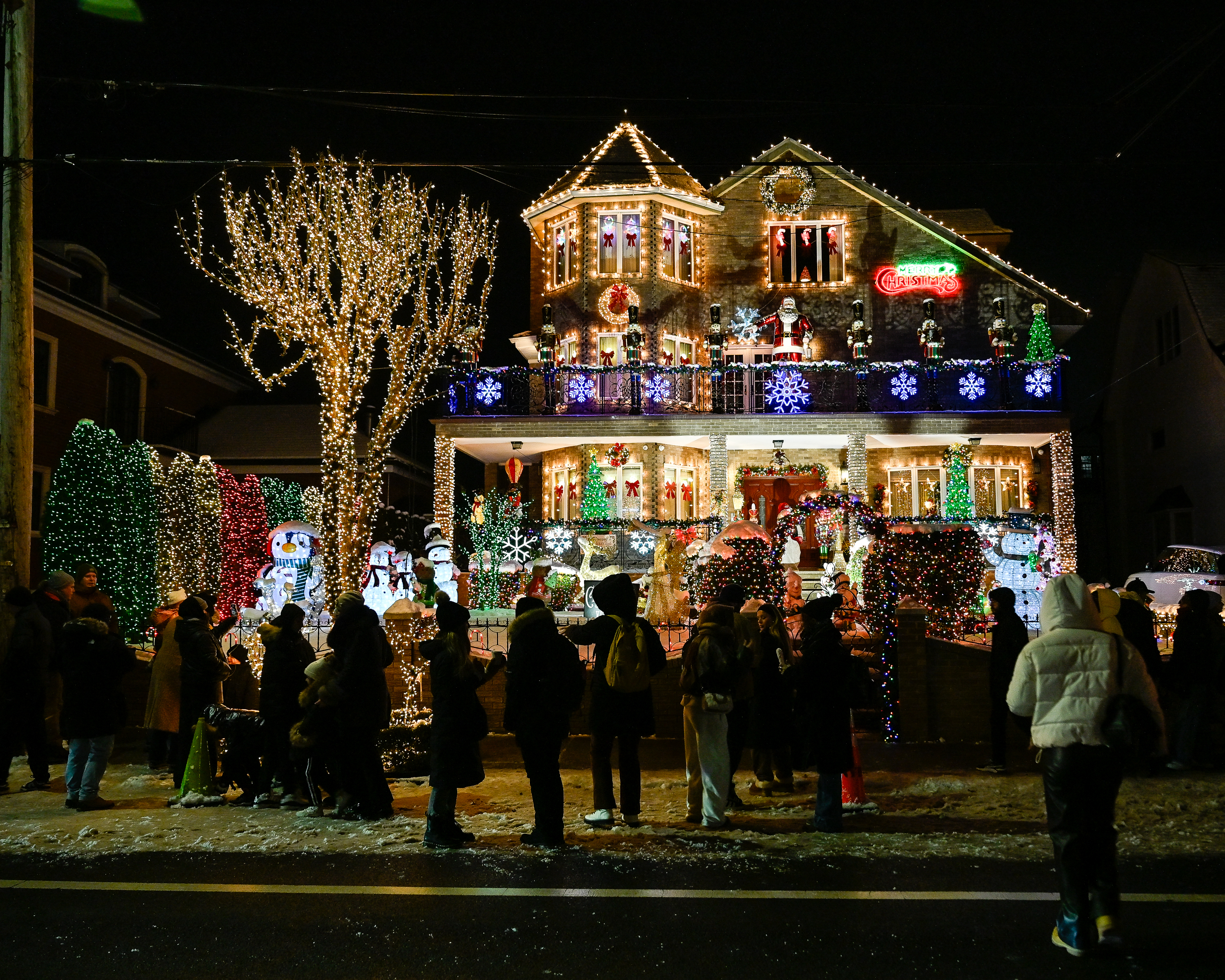 a crowd outside a decorated house
