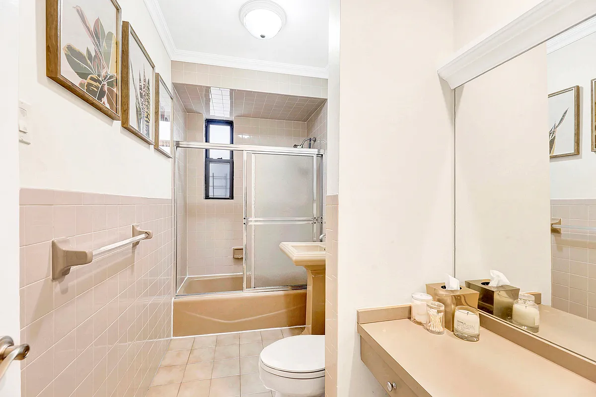bathroom with peach tub and sink