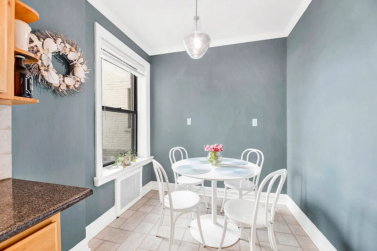 kitchen dining area with blue walls, linoleum floor