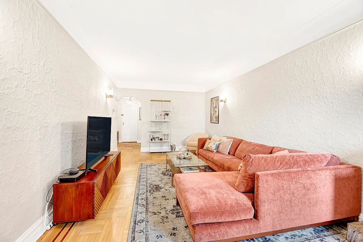 living room with textured walls, wood floor, two windows