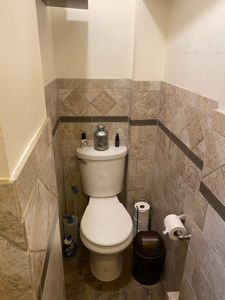 bathroom with beige tile on walls and floor