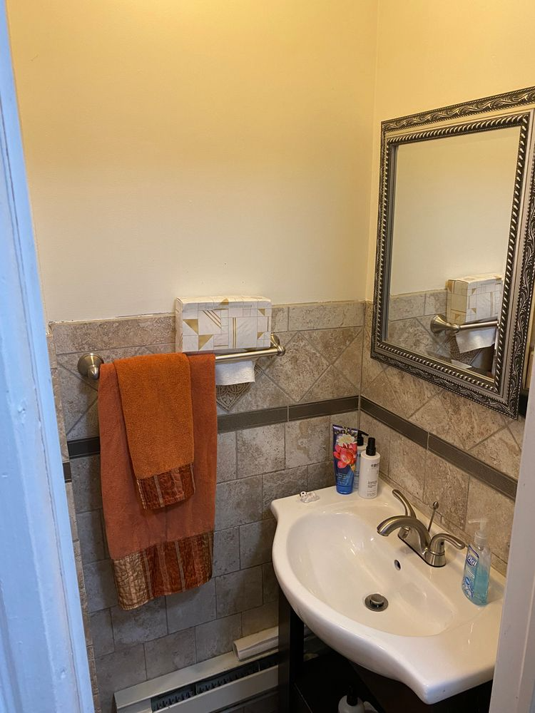 bathroom with white sink and beige tile