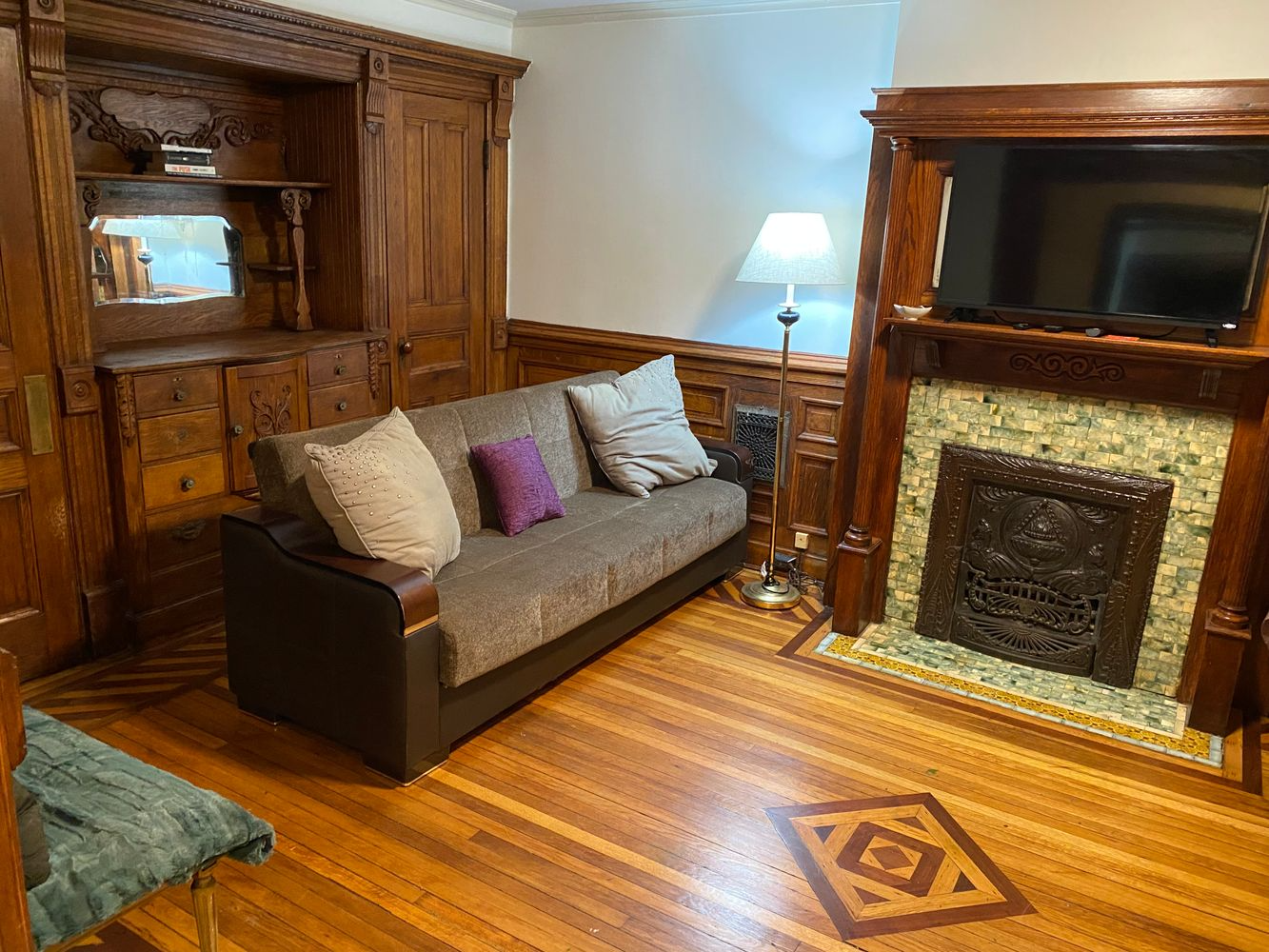 bedroom with mantel, wood floor, built-in