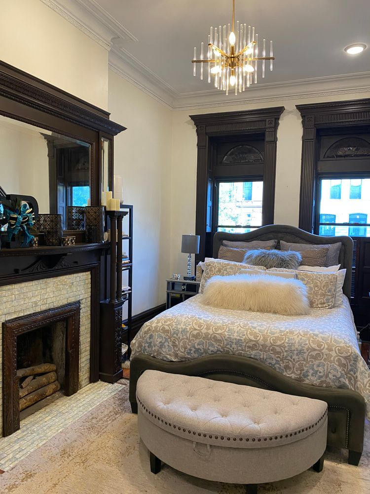 bedroom with a mantel and moldings