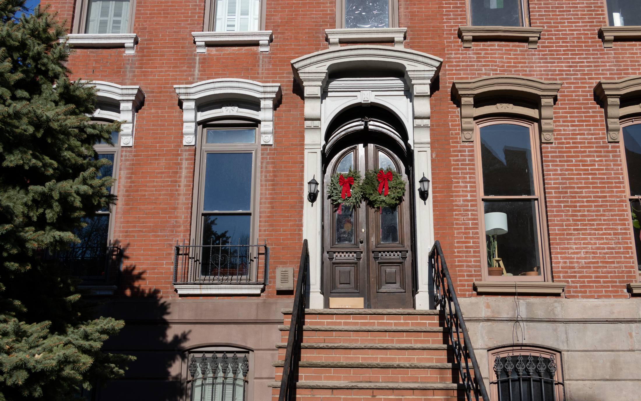 stoop and a front door with a christmas wreath