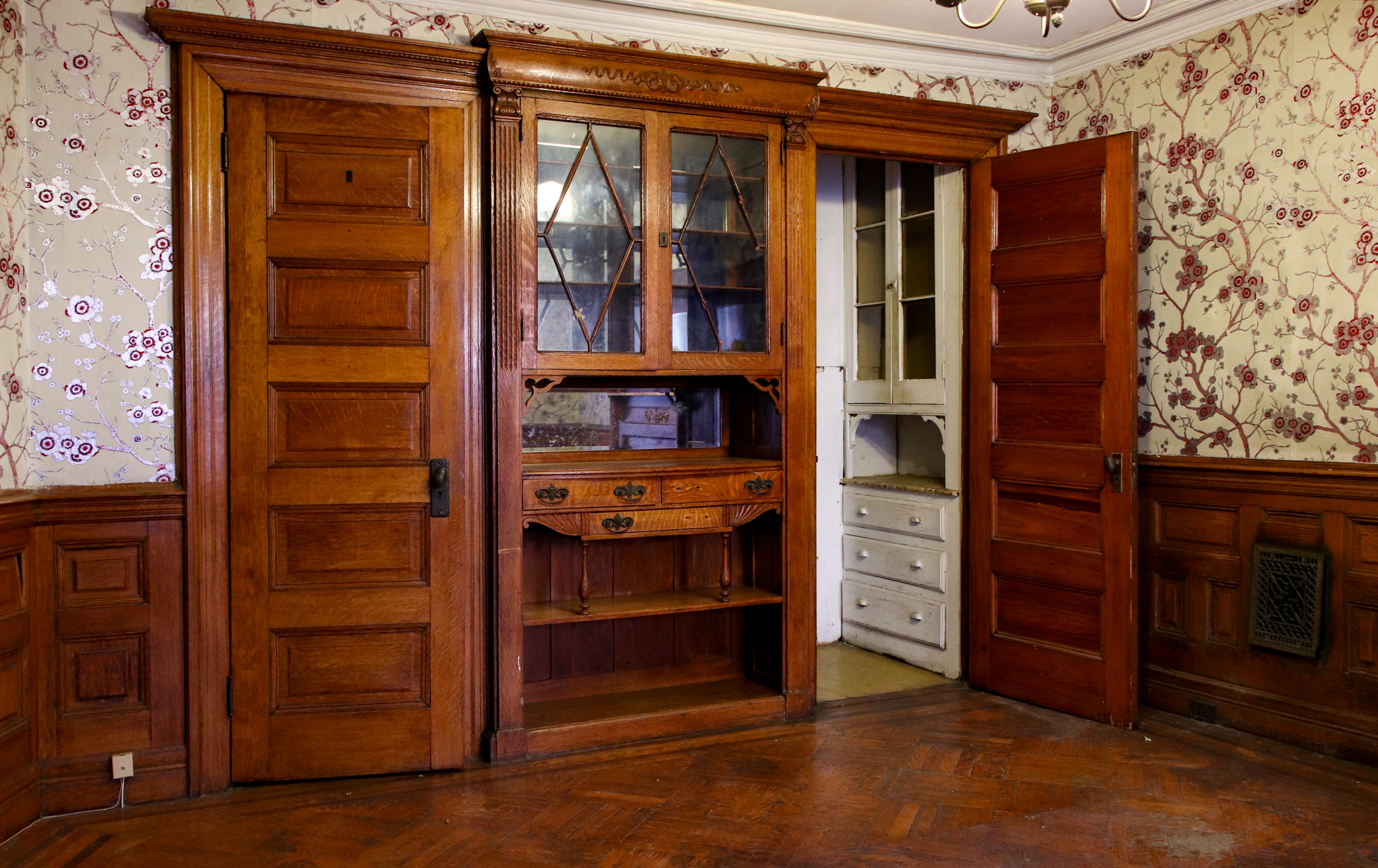 dining room with built-in cabinet and a door leading to a pantry