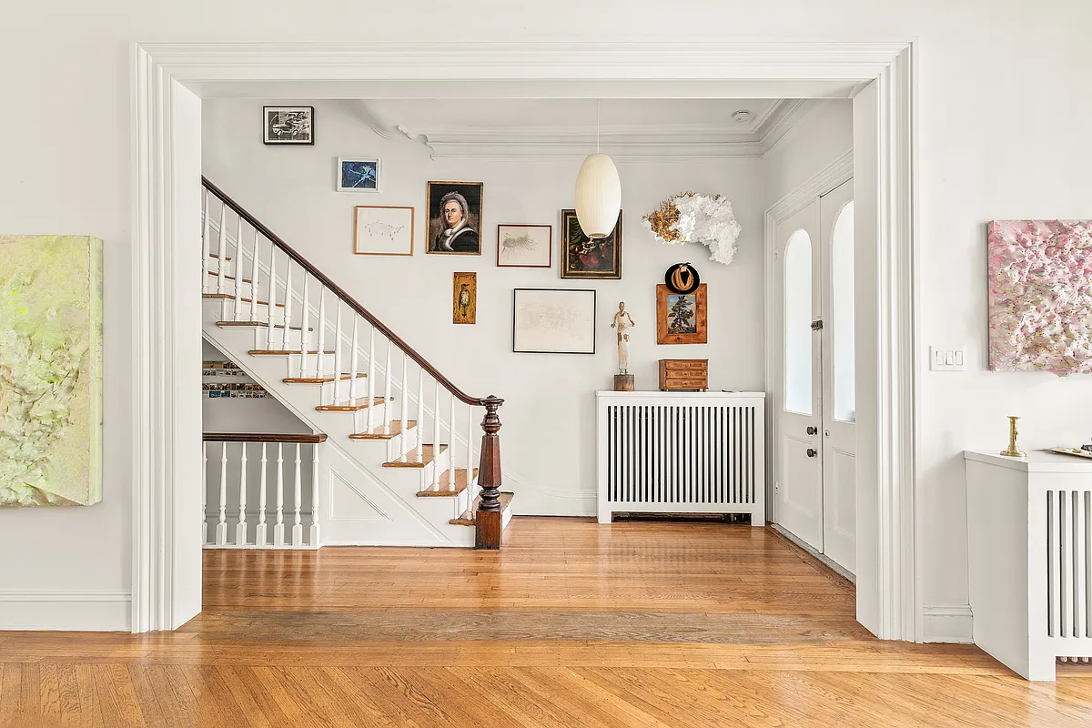entry with stair, newel post and wood floor