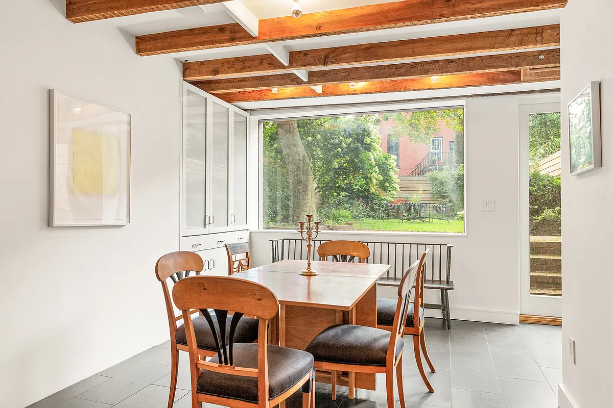 dining area in kitchen with a exposed rafters and glass door to back yard