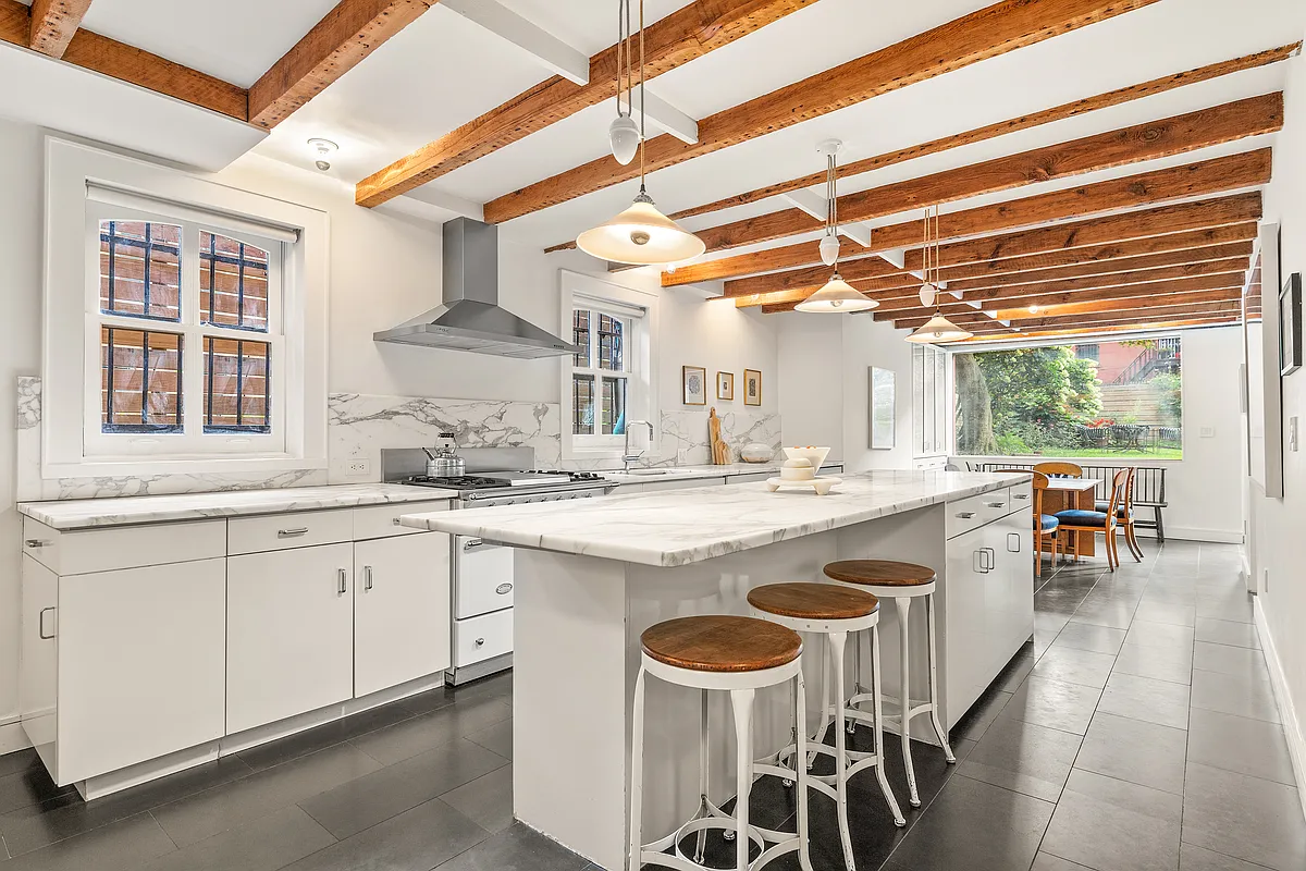 kitchen with exposed rafters, white cabinets