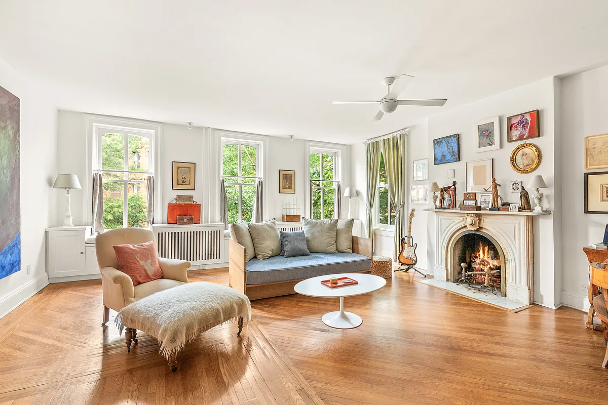 room with marble mantel and wood floor