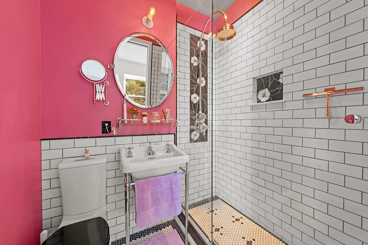 bathroom with white subway tile, pink walls