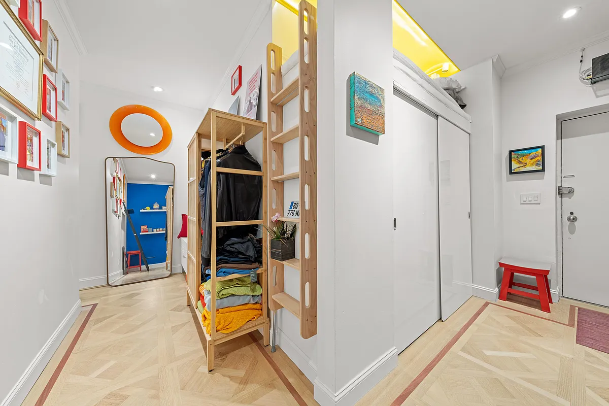 entry with closets and a loft bed