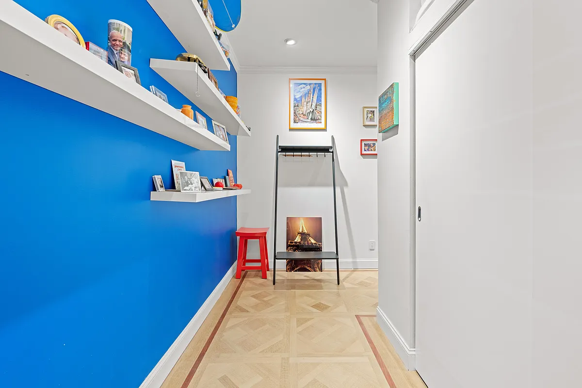 hallway with blue wall and wood floor