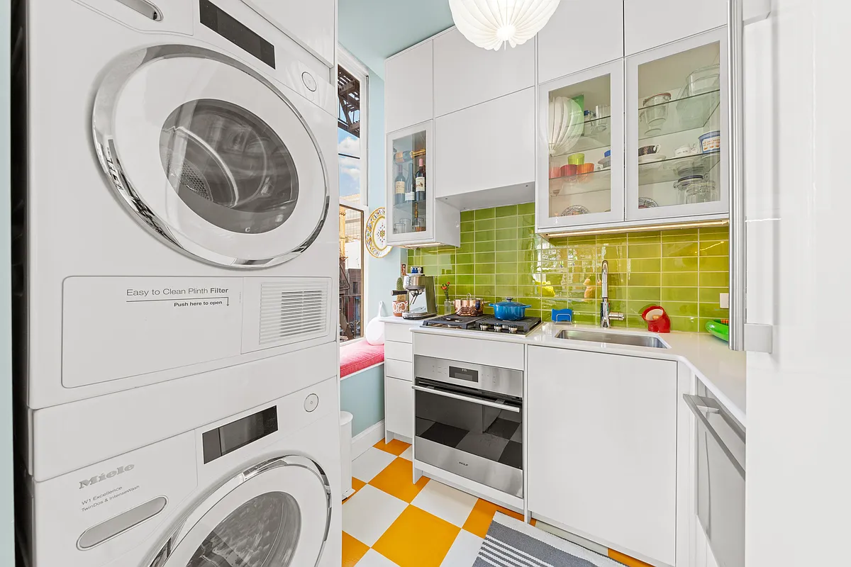 kitchen with white cabinets and bright green backsplash